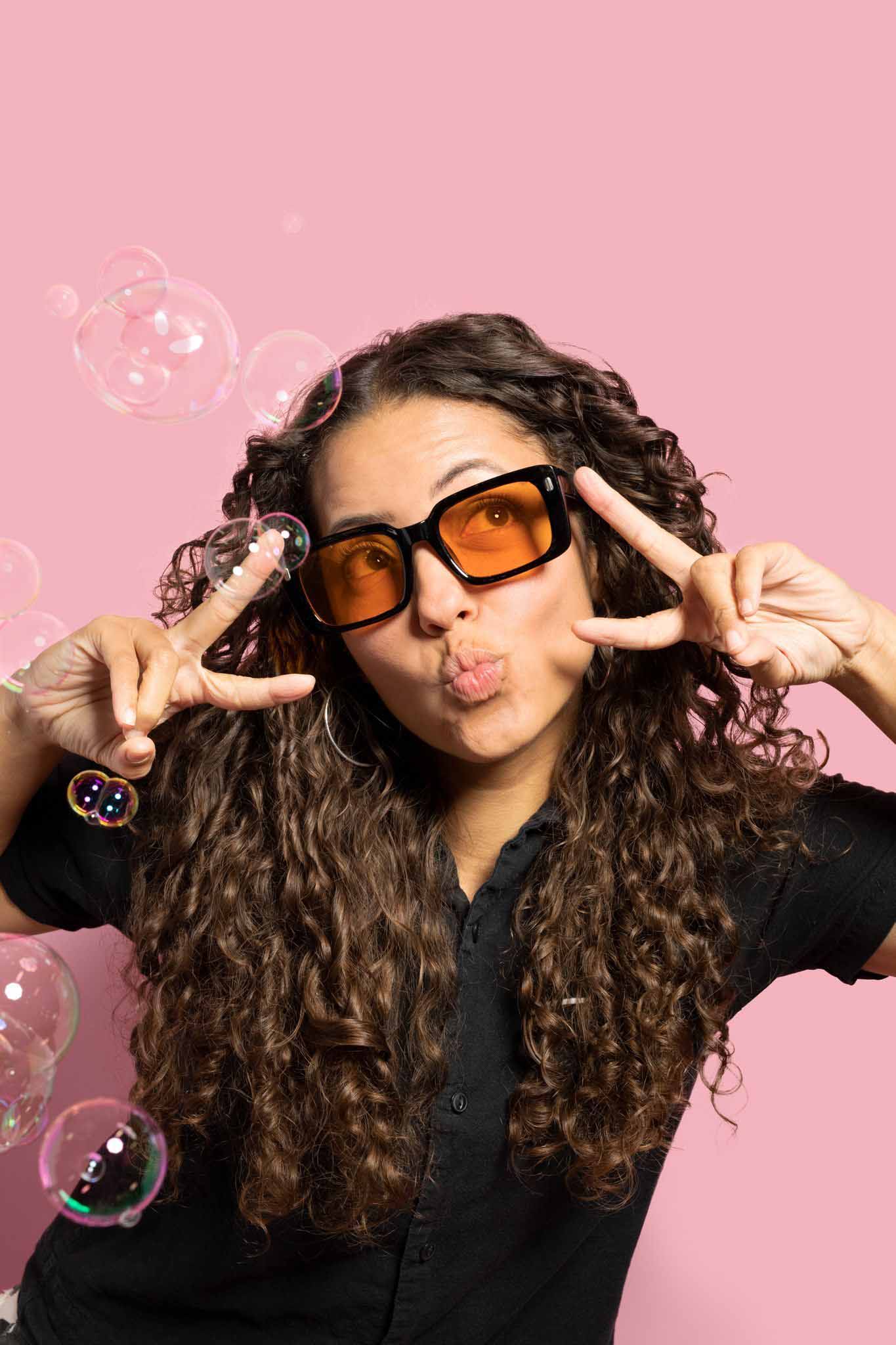 a woman on a pink backdrop